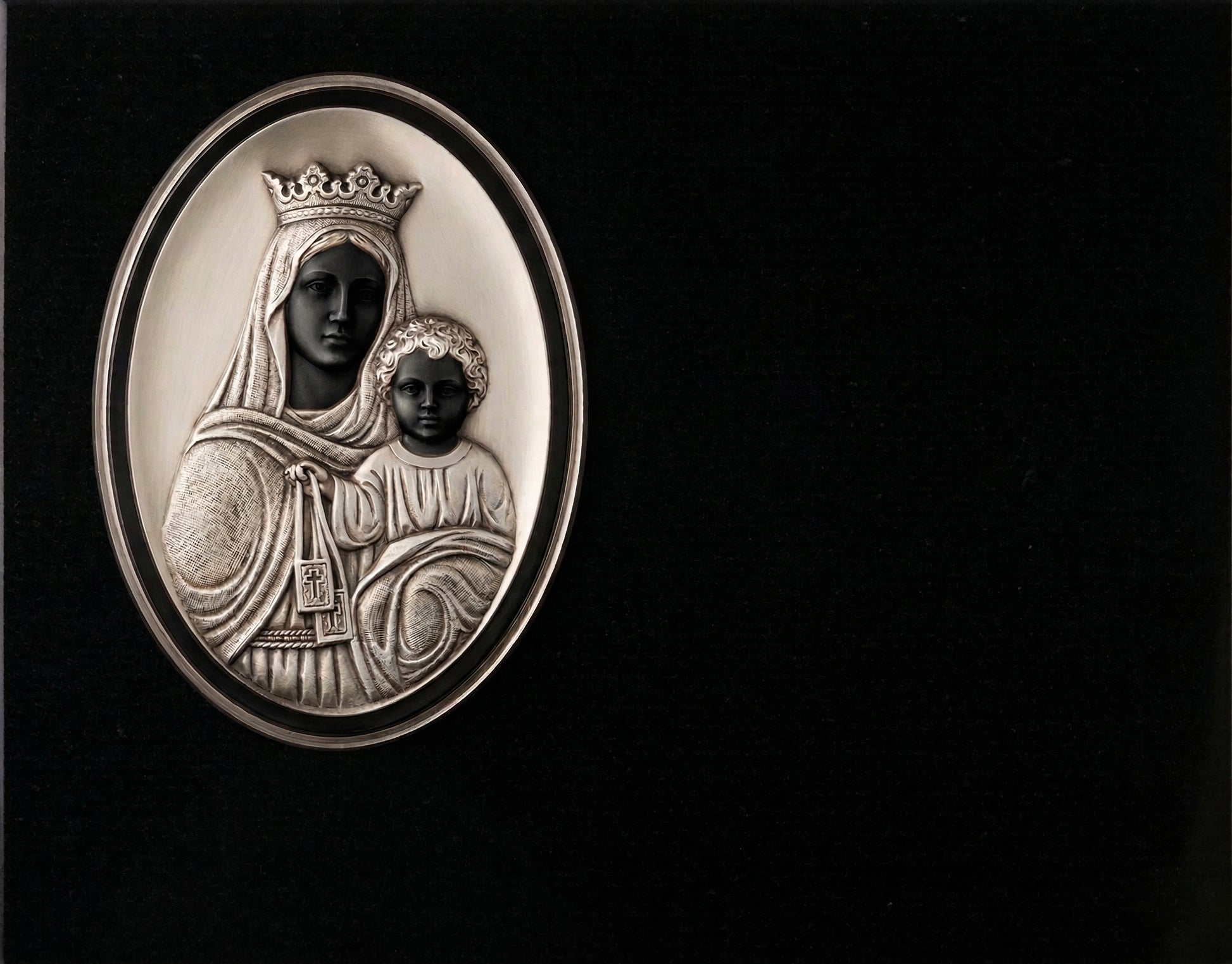 Lápida de nicho en granito negro con imagen de la Virgen del Carmen tallada. Trabajo artesanal, gran durabilidad y acabado elegante para cementerios.