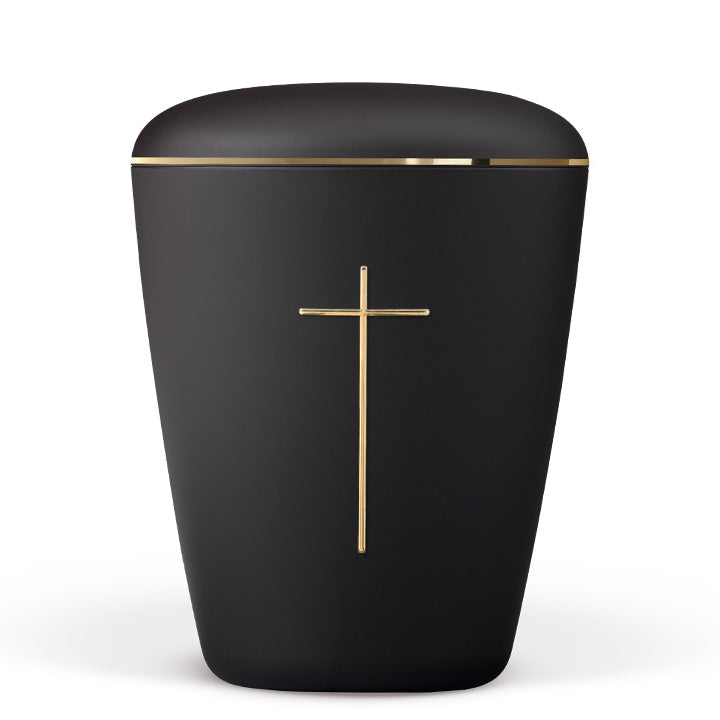 Urna funeraria ecológica de color negro mate con una cruz dorada grabada en el centro y una banda metalizada dorada en el borde superior, fotografiada sobre fondo blanco.