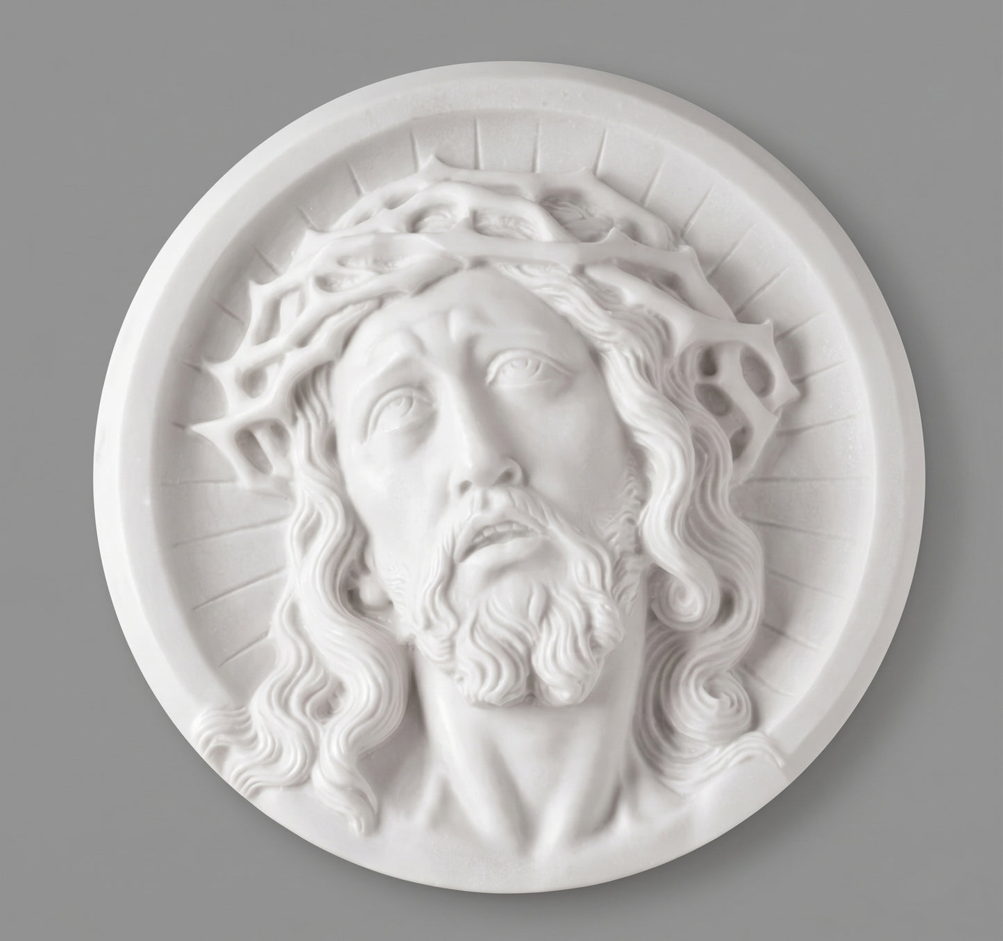 Medallón de marmolina con rostro de Cristo para la decoración de lápidas. Disponible en 10, 14 y 21 cm. Apto para cementerios.