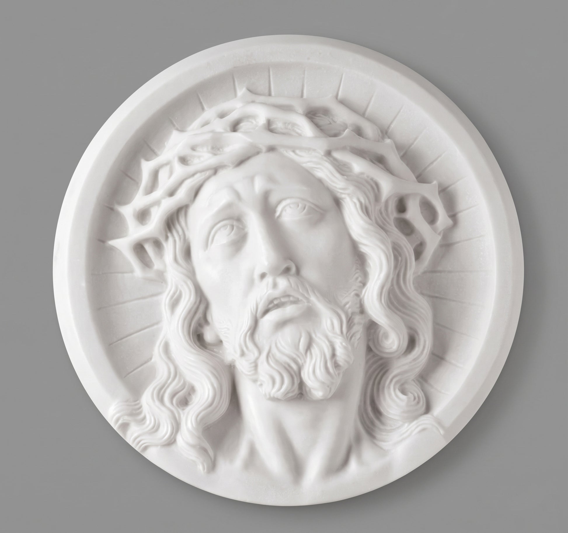 Medallón de marmolina con rostro de Cristo para la decoración de lápidas. Disponible en 10, 14 y 21 cm. Apto para cementerios.